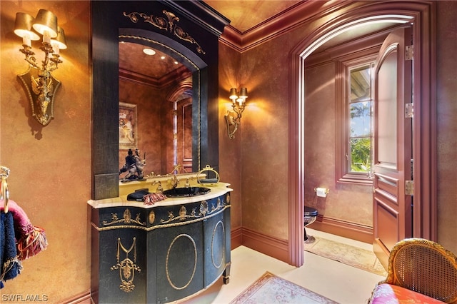 bathroom with vanity, toilet, and crown molding