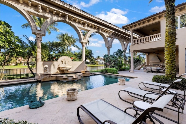 view of pool with a patio area, ceiling fan, and a jacuzzi