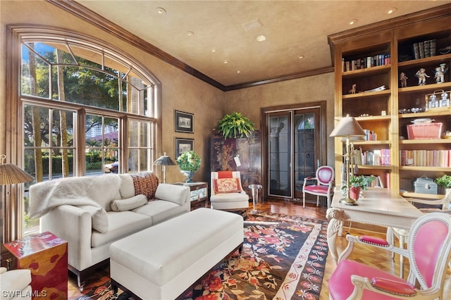 sitting room with hardwood / wood-style floors and ornamental molding