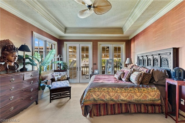 carpeted bedroom with a raised ceiling, access to exterior, ceiling fan, and french doors