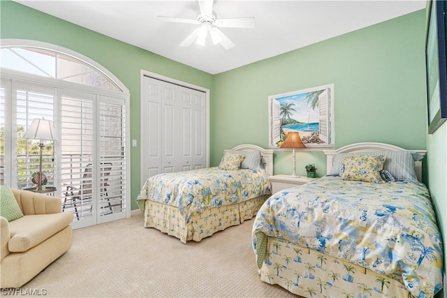 bedroom featuring ceiling fan, a closet, and light carpet