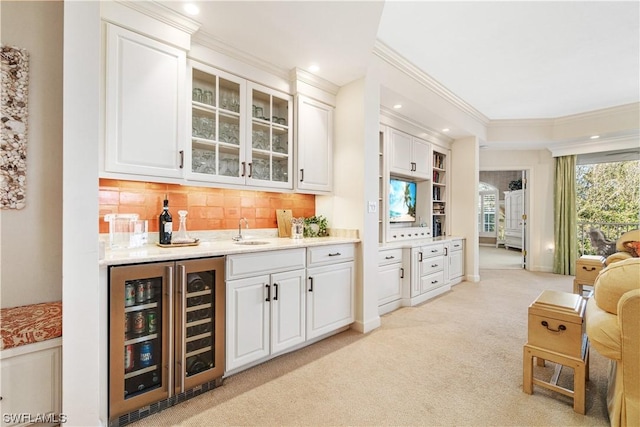 bar featuring white cabinetry, light carpet, sink, backsplash, and wine cooler