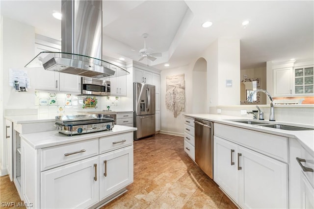 kitchen with ceiling fan, white cabinetry, island exhaust hood, and appliances with stainless steel finishes