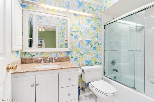 full bathroom with ceiling fan, toilet, vanity, and shower / bath combination with glass door