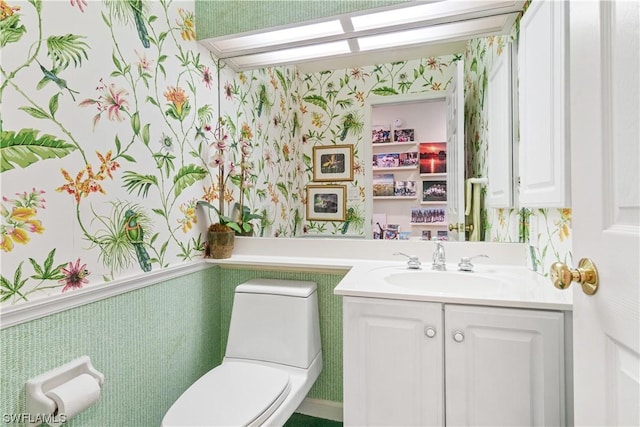 bathroom featuring toilet and vanity