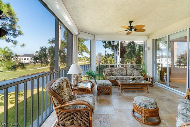 sunroom / solarium featuring ceiling fan and a wealth of natural light