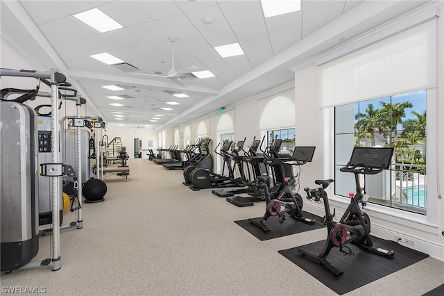 exercise room with a drop ceiling and ceiling fan