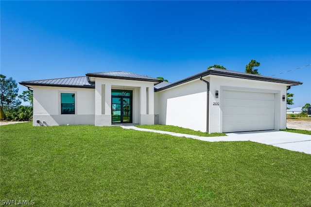 view of front of home with a front lawn and a garage