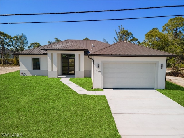 view of front of house featuring a garage and a front yard