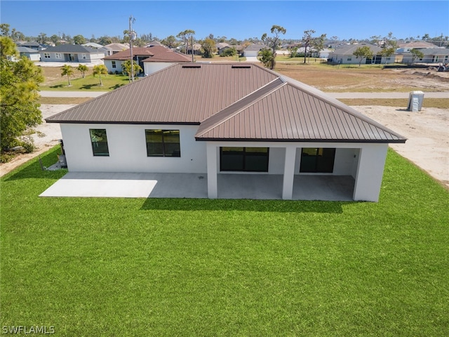 back of house with a lawn