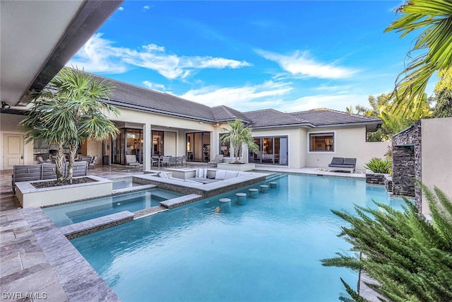 view of swimming pool featuring a patio, an in ground hot tub, and an outdoor living space