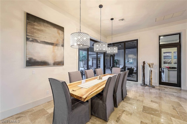 tiled dining room featuring a notable chandelier