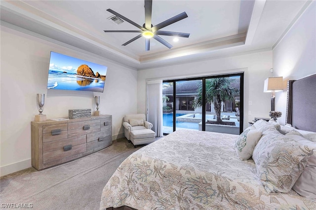 carpeted bedroom with a raised ceiling, ceiling fan, and access to outside