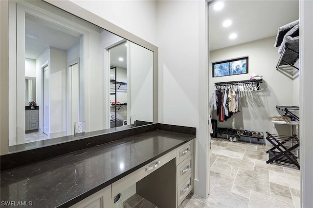 bathroom featuring tile flooring and vanity