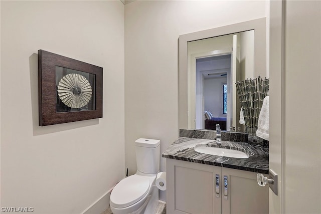 bathroom featuring toilet and vanity