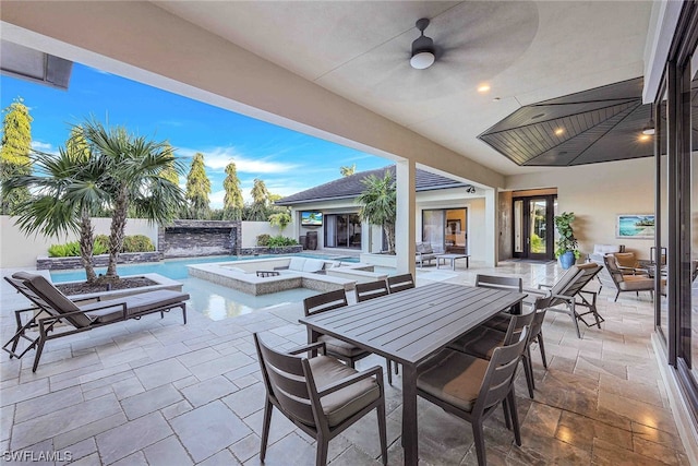 view of patio / terrace with a swimming pool with hot tub and ceiling fan