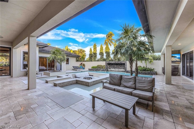 view of patio / terrace with an outdoor living space with a fire pit