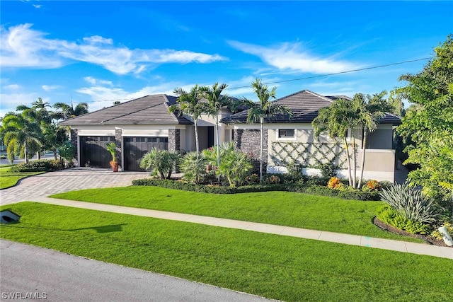 ranch-style home with a front yard and a garage