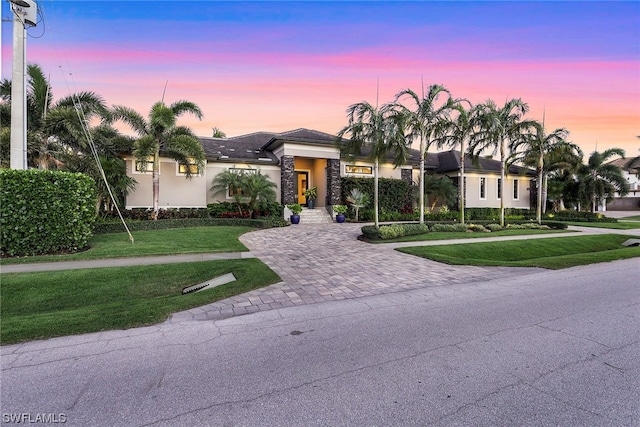 view of front of home with a lawn