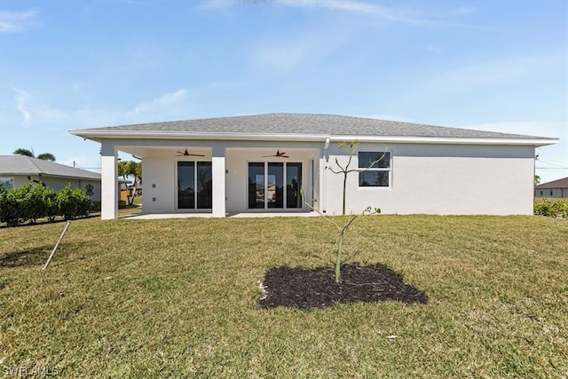 rear view of house featuring a lawn, ceiling fan, and a patio