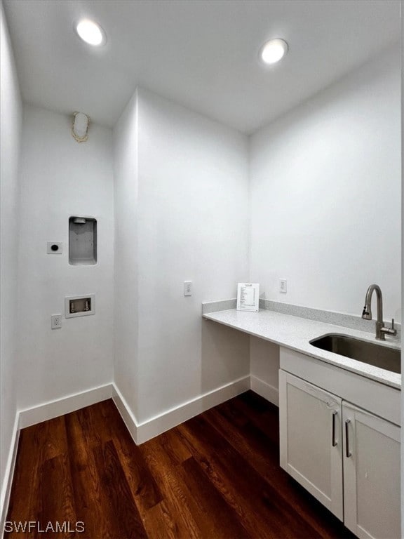 laundry area featuring washer hookup, hookup for an electric dryer, sink, dark hardwood / wood-style flooring, and cabinets