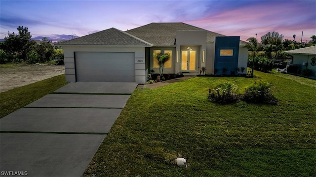 view of front facade with a garage and a yard