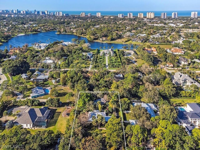 drone / aerial view with a water view and a residential view