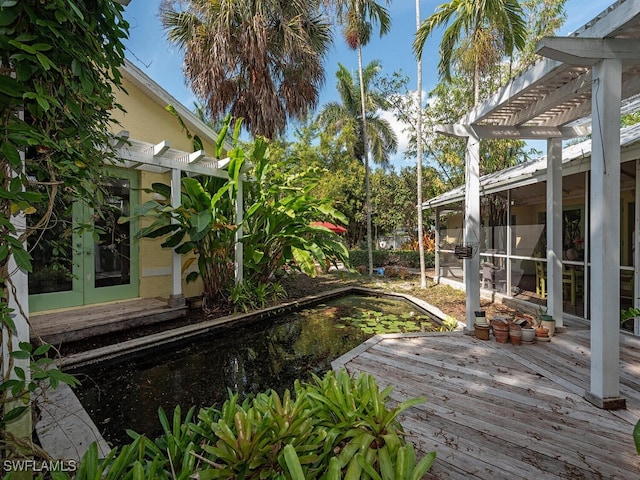 deck featuring a sunroom and a pergola