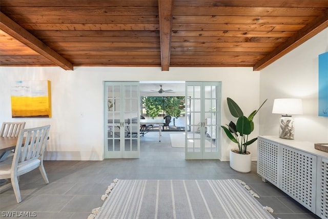 interior space featuring ceiling fan, tile flooring, french doors, vaulted ceiling with beams, and wood ceiling