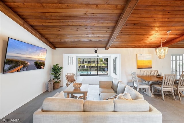 living room featuring a wealth of natural light, tile floors, a chandelier, and wood ceiling