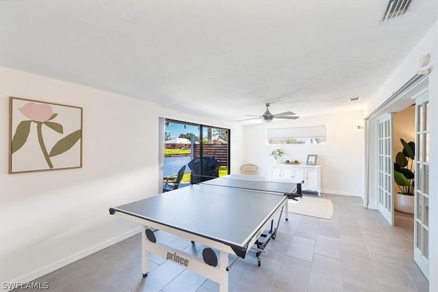 recreation room with tile floors and ceiling fan