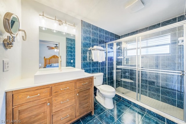 bathroom with ceiling fan, an enclosed shower, tile floors, toilet, and vanity