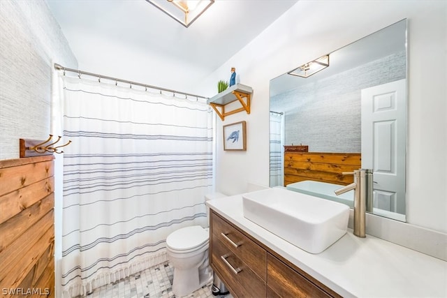 bathroom with vanity with extensive cabinet space, toilet, and tile floors