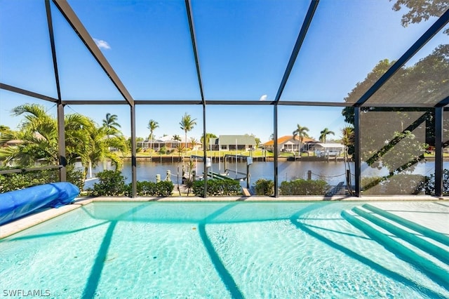 view of swimming pool featuring a lanai and a water view