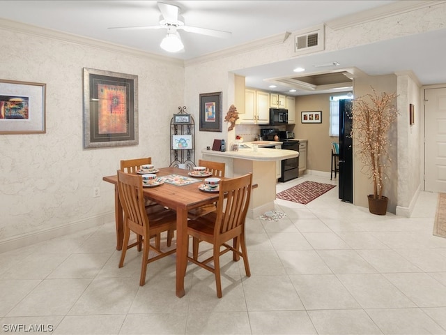 dining space with a tray ceiling, light tile floors, ceiling fan, and crown molding