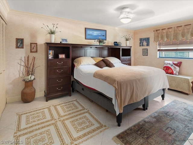 tiled bedroom featuring ceiling fan and ornamental molding