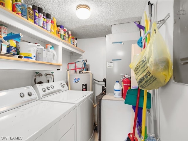 clothes washing area featuring washing machine and clothes dryer, a textured ceiling, washer hookup, and water heater