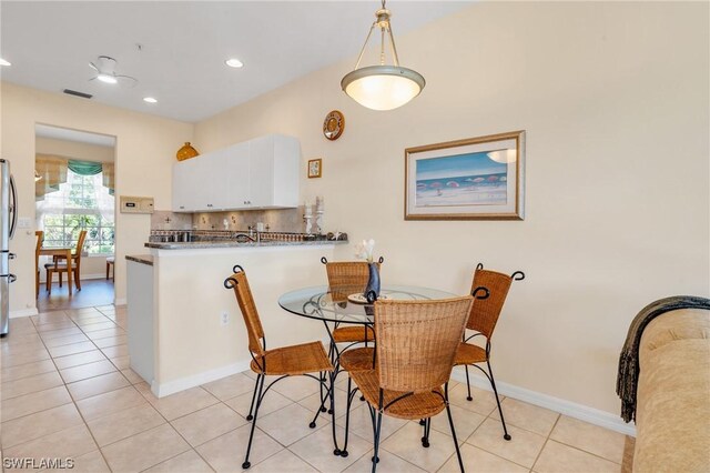 dining area with light tile patterned flooring