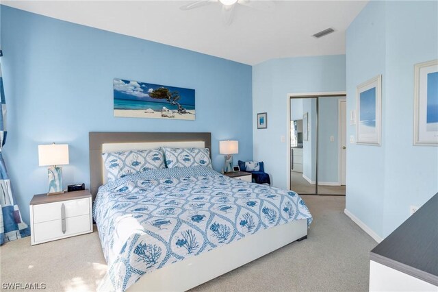 bedroom with ceiling fan, carpet floors, and a closet