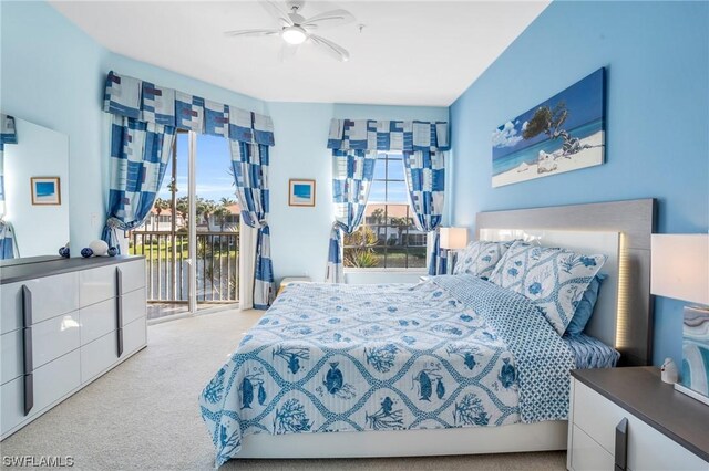 bedroom featuring multiple windows, access to outside, light colored carpet, and ceiling fan