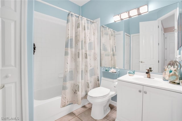 full bathroom with tile patterned flooring, toilet, vanity, and shower / bath combo with shower curtain