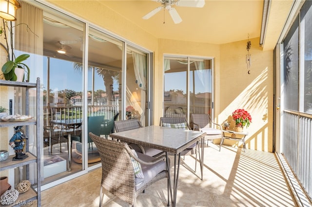 sunroom with a healthy amount of sunlight and ceiling fan