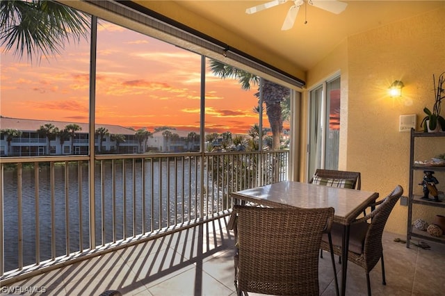 sunroom / solarium with a water view