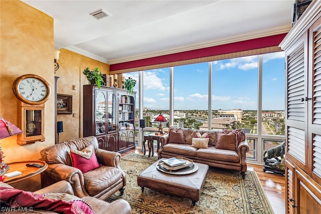 living room with light hardwood / wood-style floors and ornamental molding