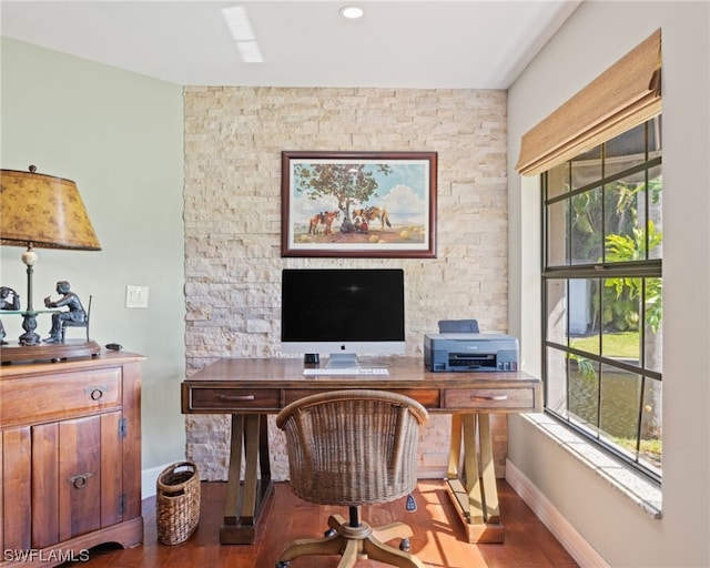 home office featuring dark hardwood / wood-style floors and a wealth of natural light