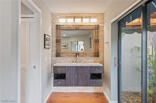 bathroom featuring large vanity and hardwood / wood-style floors