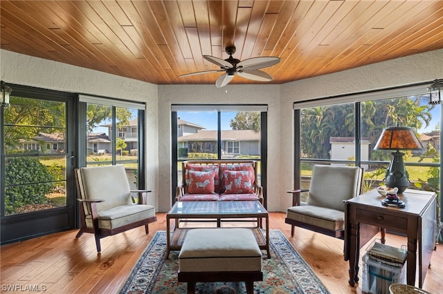 sunroom / solarium with wood ceiling and ceiling fan