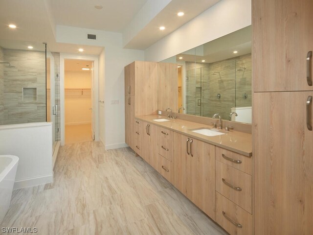 bathroom featuring vanity and separate shower and tub