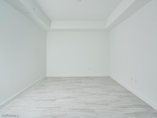 empty room with a tray ceiling