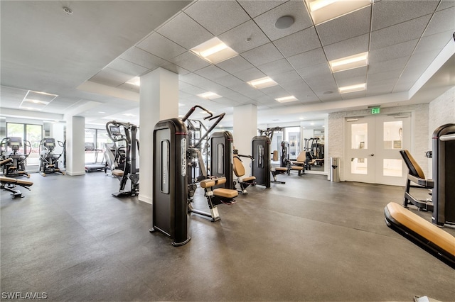 workout area with french doors and a drop ceiling